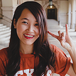 Female student doing a Hook 'Em