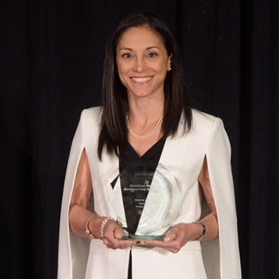 UT Law School alum Alina Nassar Jorge holds an aerospace award
