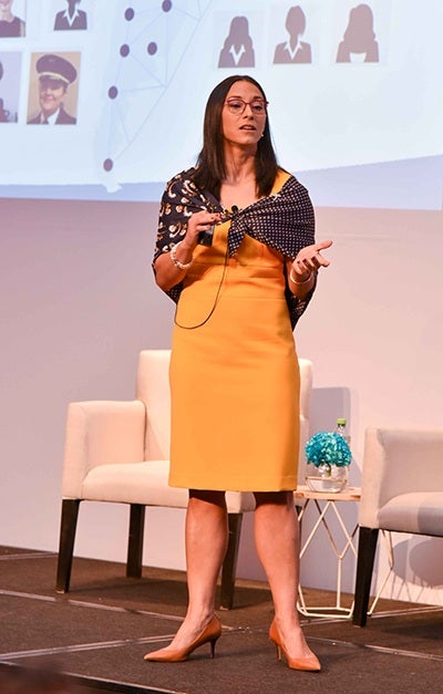 UT alum Alina Nassar speaks onstage at an aerospace conference